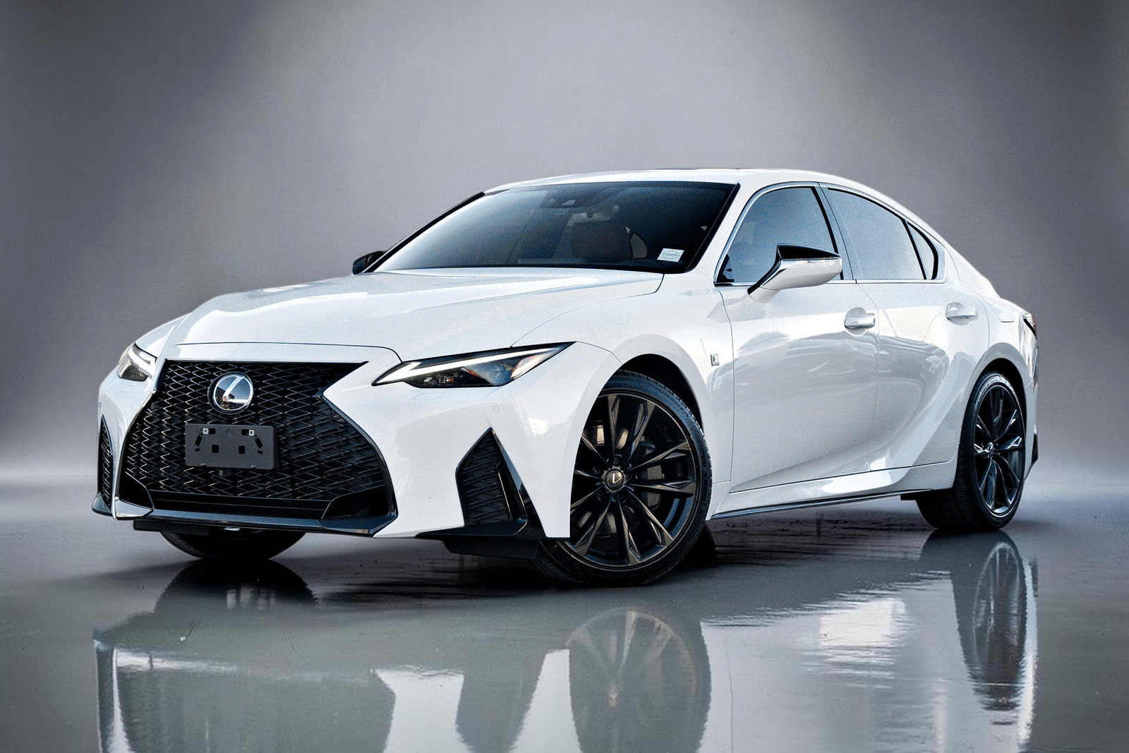 2023 Lexus IS in white, finished on a clean studio background with a soft floor reflection.