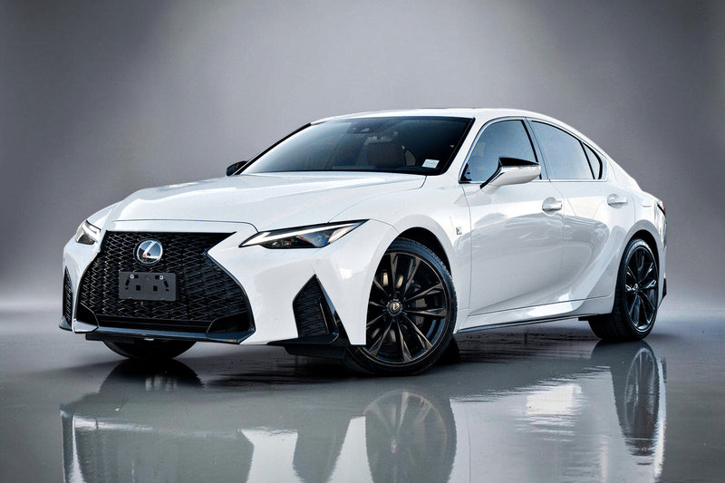 2023 Lexus IS in white, finished on a clean studio background with a soft floor reflection.